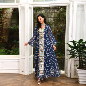 Detailed embroidery and sequins on navy bohemian dress with abstract white textures