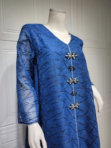 Detailed V-neck of navy blue dress featuring crystal flower embellishments and mesh texture