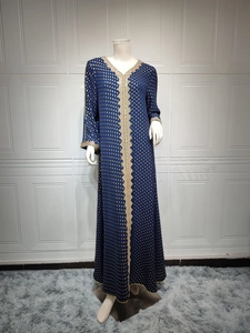 Detail der ethnischen Goldstickerei am dunkelblauen Abaya-Kleid mit Trompetenärmeln