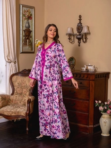 Detailed view of the purple floral kaftan dress with satin borders and decorative buttons