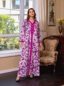 Detail of V-neckline and floral print on long sleeve kaftan dress in pink and purple