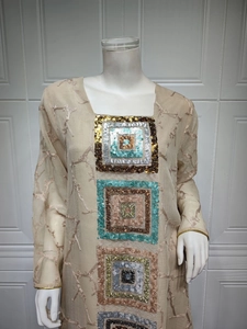 Detail of beige sequin embroidered square patterns on ethnic long sleeve dress