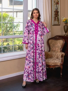 Detail of floral print maxi dress with contrast ribbon trim and buttoned neckline