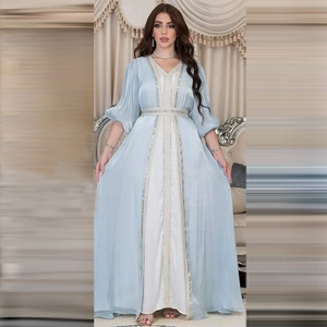 Close-up of light blue satin kaftan with intricate silver sequin embroidery on sleeves