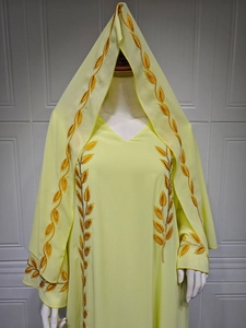 Macro detail of gold wheat embroidery on the light yellow chiffon modest dress set