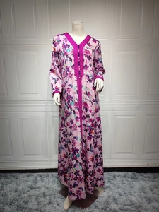 Detail of purple embroidery and spherical buttons on this floral printed kaftan dress