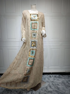 Detail of sequin embroidery patterns on a beige long sleeve ethnic kaftan dress