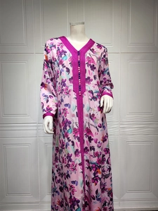 Detail of floral kaftan dress with purple braided trim and intricate beadwork accents