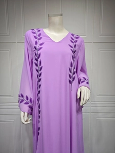 Detail view of purple chiffon kaftan showing intricate leaf embroidery on V-neck and sleeves