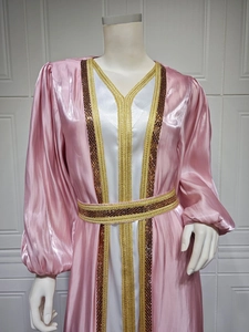 Detail of hot-drilled sequins and embroidery on luxurious pink satin caftan sleeve