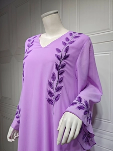 Close-up of purple chiffon dress with detailed vine leaf embroidery on v-neck and shoulder