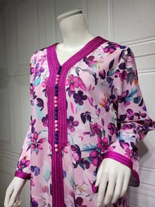 Detail of floral chiffon dress showing purple woven lace trim and decorative buttons
