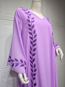Detailed embroidery of purple leaves on a light chiffon abaya dress with bell sleeves