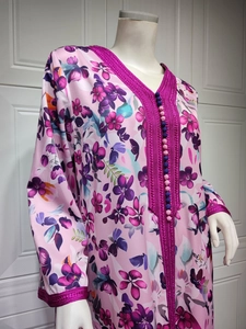 Detail of V-neckline with pink embroidery and bead buttons on floral long sleeve dress