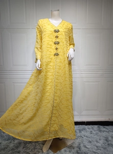 Detail of yellow V-neck Kaftan dress with diamond floral accents and gold texture patterns