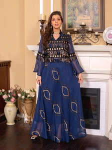 Detail of dark blue evening dress with intricate gold sequins and fringe embroidery
