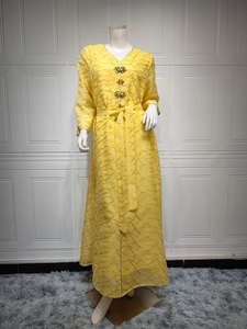 Full view of yellow V-neck maxi dress with geometric texture and rhinestone buttons
