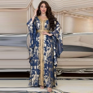 Detailed embroidery on the V-neck and gold foil patterns of this navy blue kaftan dress