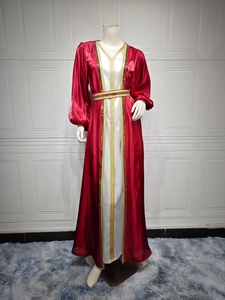 Detailed view of the luxury rhinestone satin dress with golden embroidery and sequins