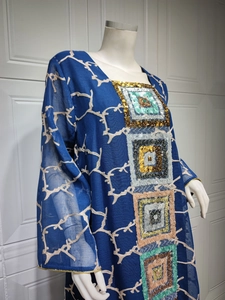 Detail of navy blue chiffon dress showing sequins embroidery and wave textures