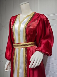 Close-up of golden embroidery and dark sequins on a luxury satin gown set