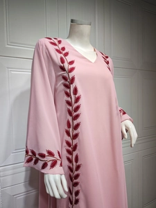 Close-up of red leaf embroidery details on a pink chiffon kaftan abaya dress