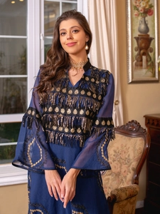 Detail of dark blue formal dress with gold sequins and long tassel fringe embroidery