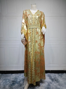 Detail of ethnic style chiffon maxi dress featuring golden embroidery and metallic print