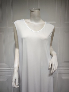 White V-neck sleeveless knitted maxi dress shown on a mannequin with a loose fit drape