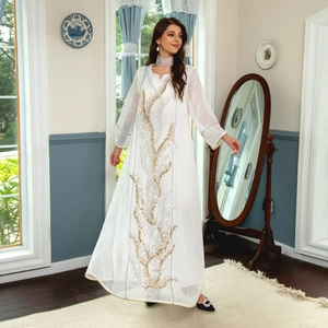 Elegant white long sleeve oversized maxi dress featuring golden sequin tree embroidery