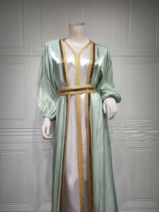 Detail of mint green Moroccan Kaftan with gold sequin embroidery and satin finish