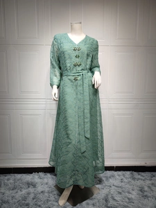 Detail of green mesh Abaya dress featuring intricate beaded crystals and geometric embroidery