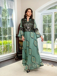 Detailed embroidery with gold sequins and black coins on a sage green evening dress