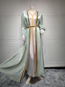 Detailed view of the light green satin kaftan robe with intricate gold sequin embroidery