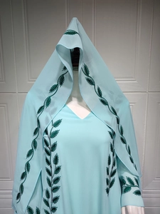 Detail of light blue chiffon Abaya with green leaf embroidery and matching hijab