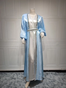 Detail of luxury satin kaftan dress with silver sequin embroidery and lantern sleeves