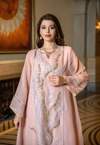 Close-up of pink Kaftan dress with elegant gold and silver sequin embroidery details.