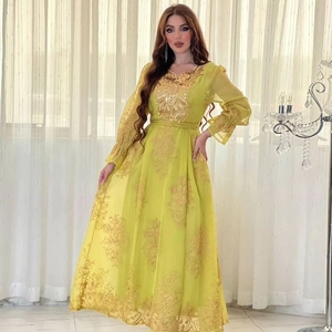 Close-up of bright yellow dress featuring intricate gold lace embroidery and beaded details