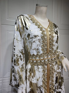 Detailed view of white chiffon kaftan with gold foil print and diamond geometric belt