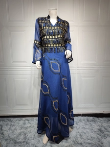 Detail of navy blue evening dress with golden sequin tassels and embroidery