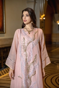 Elegant pink sequin embellished long sleeve dress with loose fit and V-neckline.