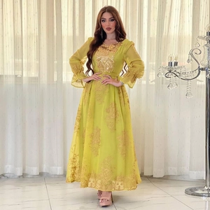 Detailed golden floral embroidery on lemon yellow dress with elegant lantern sleeves