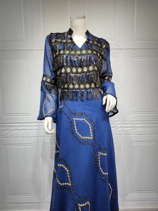 Detailed view of navy evening gown with gold sequins, beaded tassels and ethnic embroidery