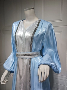 Detailed close-up of silver sequin embroidery on light blue satin luxury kaftan dress