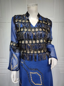 Detail of royal blue evening dress with black and gold sequin fringe and wave embroidery