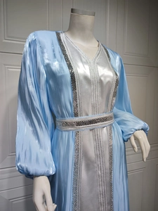 Detail of silver bead embroidery and blue satin texture on the elegant Kaftan dress