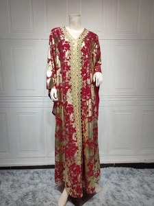 Close-up detail of golden geometric embroidery on red chiffon dress with V-neckline