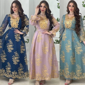 Detailed view of gold floral embroidery and sequins on long-sleeved ethnic dresses