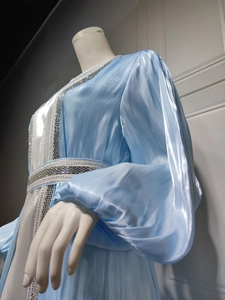 Detailed view of luxury light blue satin dress with silver beaded embroidery and waist detail
