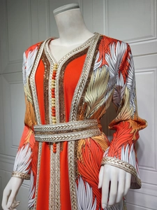 Close-up of golden braided Sfifa embroidery and ball button details on orange Kaftan robe